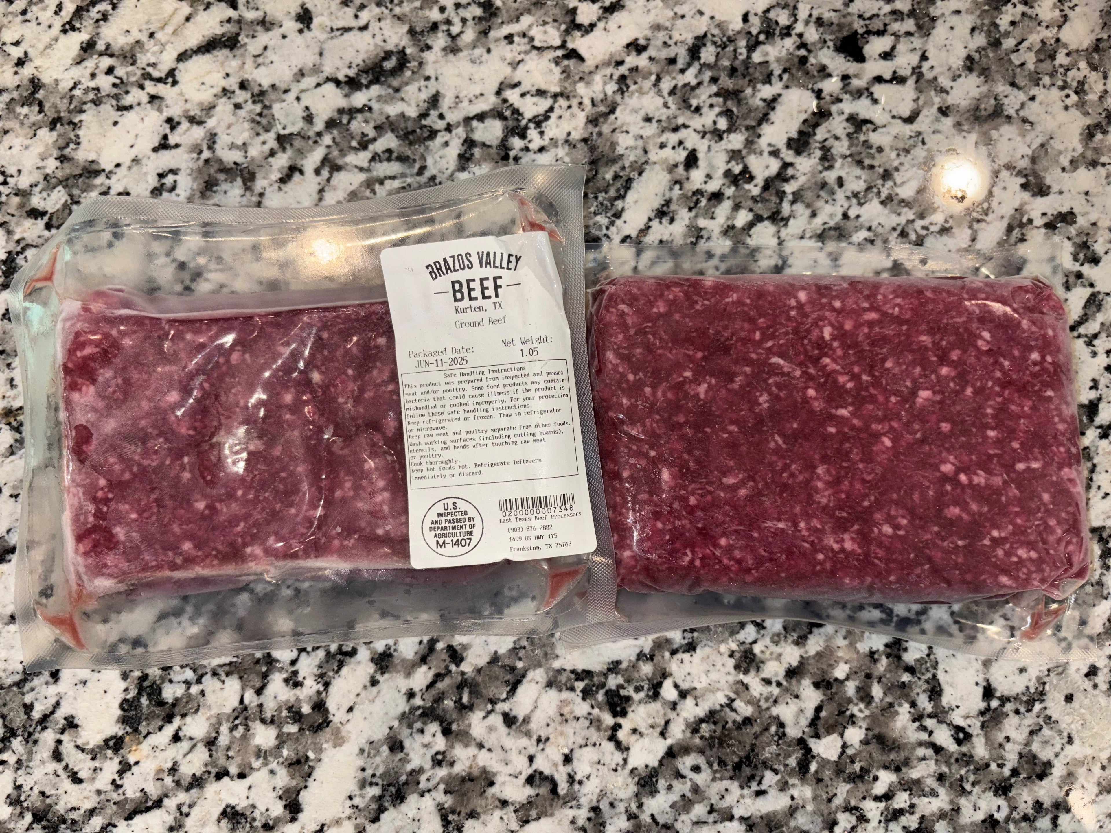 Packaged ground beef on a granite countertop